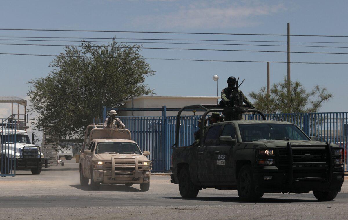 Members of the National Guard and the Mexican Army leave the airport after landing in Ciudad Juarez, state of Chihuahua, Mexico, on Aug. 12, 2022, after a rash of violence in the city. (Herika Martinez/AFP via Getty Images)