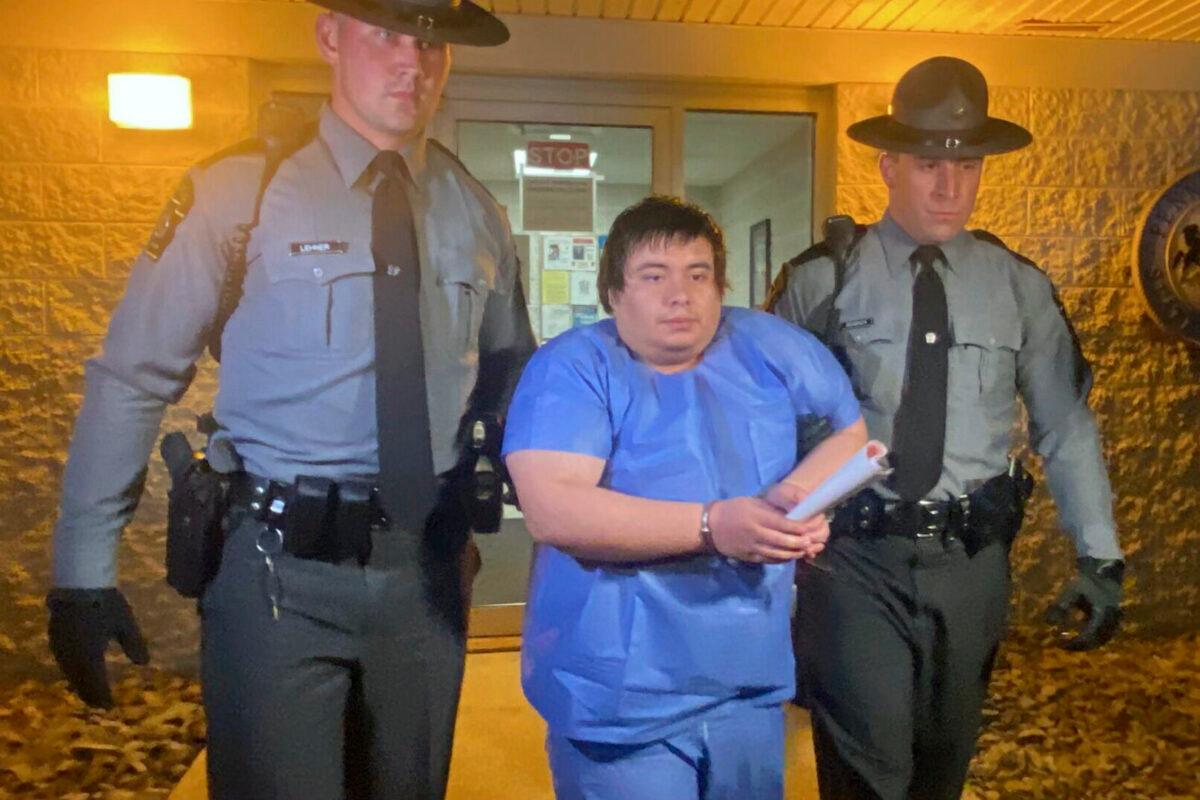 Adrian Oswaldo Sura Reyes, 24, of Nescopeck, Pa., is led from the state police barracks at Shickshinny, Pa., early on Aug. 14, 2022. (Bob Kalinowski/The Citizens' Voice via AP)