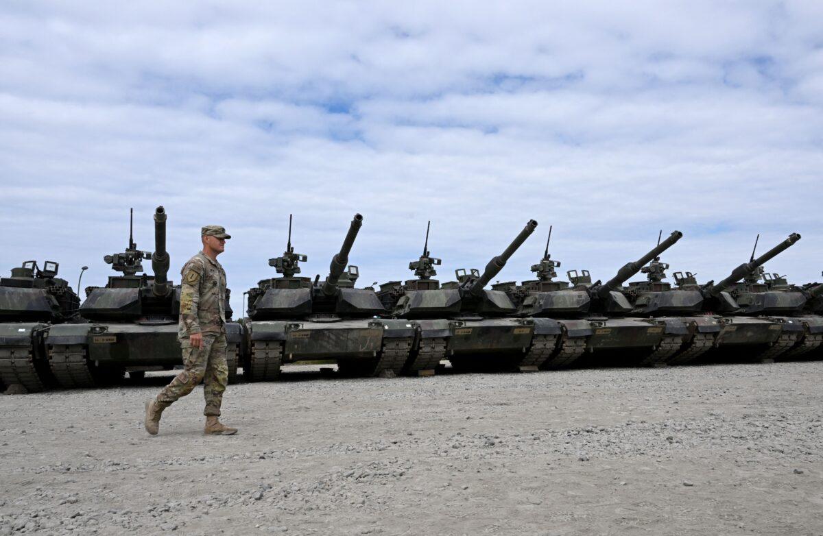 A U.S .soldier walks in front of military tanks at the United States Army military training base in Grafenwoehr, southern Germany, on July 13, 2022. (Christof Stache/AFP via Getty Images)