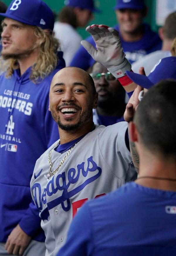 Mookie Betts #50 of the Los Angeles Dodgers celebrates his home run with teammates in the first inning against the Kansas City Royals at Kauffman Stadium in Kansas City, on August 13, 2022. (Ed Zurga/Getty Images)