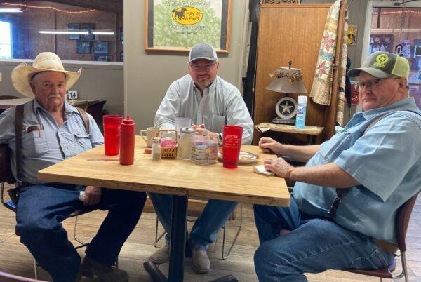 Cattle ranchers Brent Key (L), Michael Franke (C), and Ricky Carouth (R) enjoy breakfast at Jean's Feedbarn in Cross Plains, Texas, on Aug. 9, 2022. Key and Carouth recently sold their cattle amid the drought. Franke said he's concerned about rising prices of feed and the lack of water needed to maintain his herd. (Allan Stein/The Epoch Times)