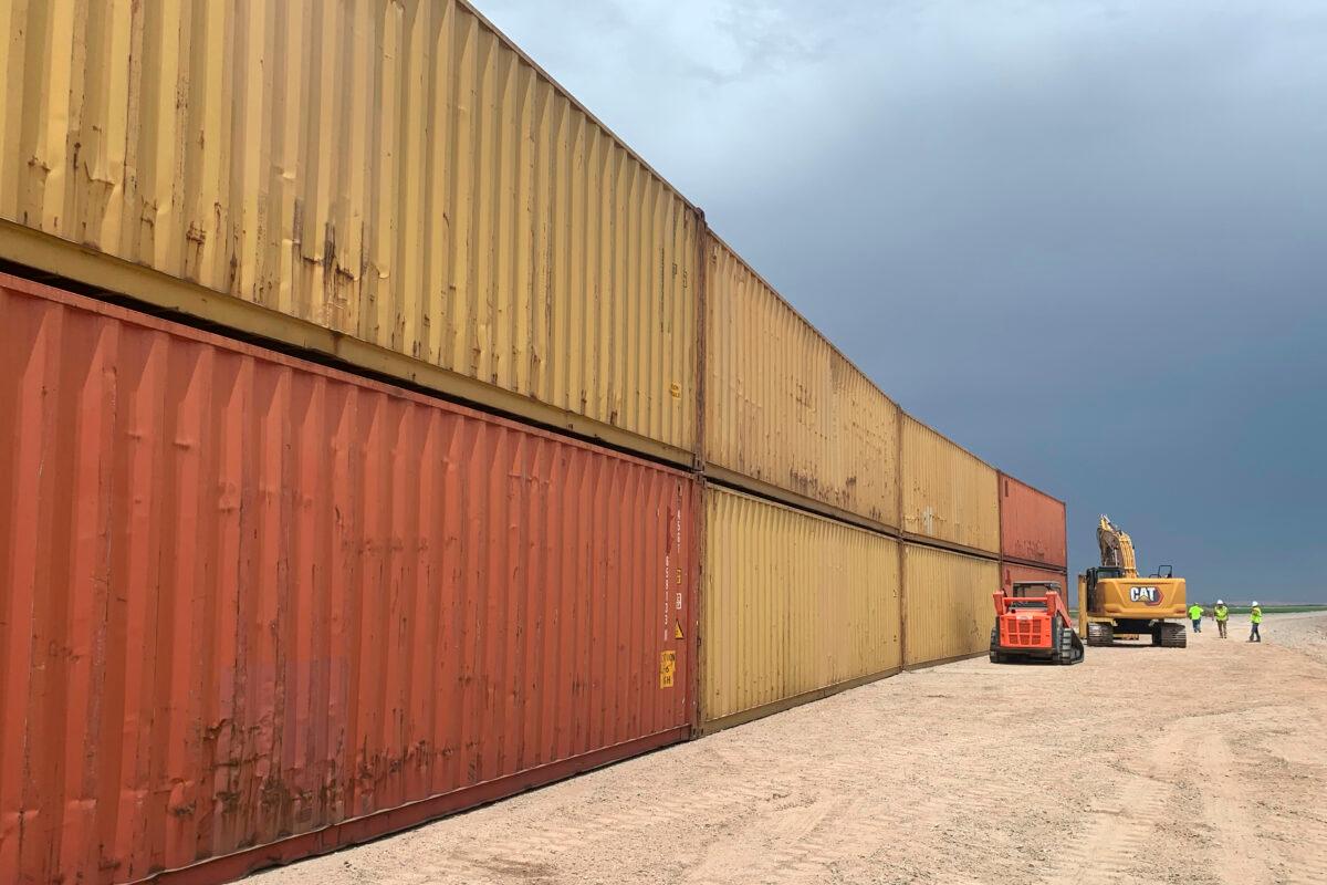 Shipping containers that will be used to fill a 1,000-foot gap in the border wall with Mexico near Yuma, Ariz., on Aug. 12, 2022. (Arizona Governor's Office via AP)