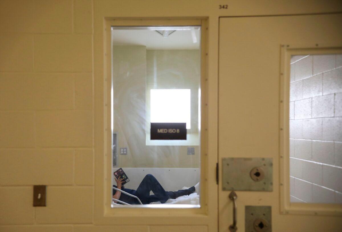 An inmate reads a book while in the infirmary at Las Colinas Women's Detention Facility in Santee, Calif., on April 22, 2020. (Sandy Huffaker/AFP via Getty Images)