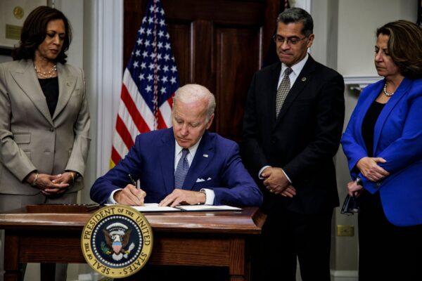 President Joe Biden signs an executive order directing the Department of Health and Human Services (HHS) to ensure access to abortions while Vice President Kamala Harris, HHS Secretary Xavier Becerra, and Deputy Attorney General Lisa Monaco look on at the White House on July 8, 2022. (Samuel Corum, AFP/Getty Images)