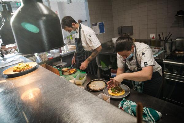 Staff at Lobbs Cafe in Brunswick prepare food in Melbourne, Australia, on Oct. 22, 2021. (Darrian Traynor/Getty Images)