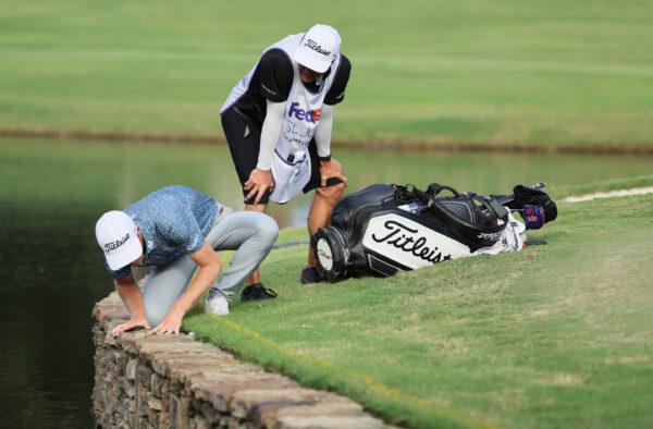 Will Zalatoris of the United States talks with his caddie on the third playoff hole on the 11th green after his ball went in the water during the final round of the FedEx St. Jude Championship at TPC Southwind in Memphis, August 14, 2022, Tennessee. (Andy Lyons/Getty Images)