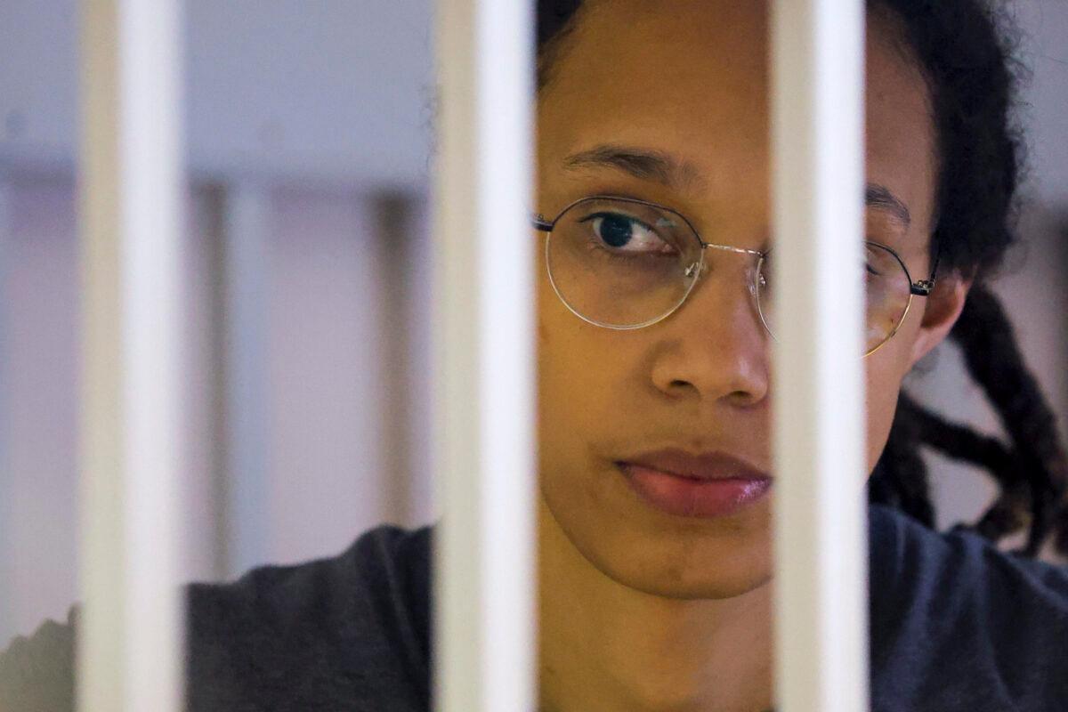 U.S. Basketball player Brittney Griner looks through bars as she listens to the verdict standing in a cage in a courtroom in Khimki, outside Moscow on Aug. 4, 2022. (Evgenia Novozhenina/Pool via AP)