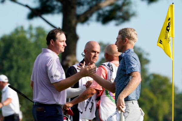 Will Zalatoris, right, greets Sepp Straka, of Austria, after defeating Straka in a playoff in the final round of the St. Jude Championship golf tournament in Memphis, Sunday, Aug. 14, 2022. (Mark Humphrey/AP Photo)
