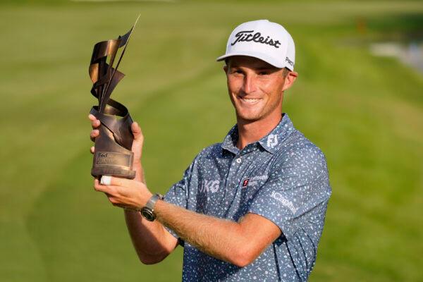 Will Zalatoris holds the trophy after winning the St. Jude Championship golf tournament in Memphis, August 14, 2022. (Mark Humphrey/AP Photo)
