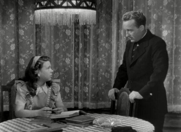 Joan Carroll as Patsy Gallagher talks with Bing Crosby as Father O'Malley about her future in "The Bells of St. Mary's." (RKO Pictures)