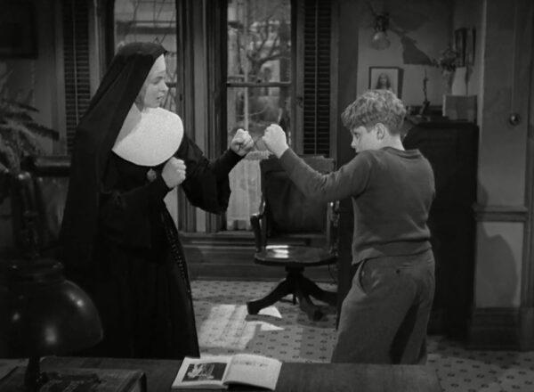 Ingrid Bergman as Sister Benedict shows Dick Tyler as Eddie Breen how to defend himself in "The Bells of St. Mary's." (RKO Pictures)