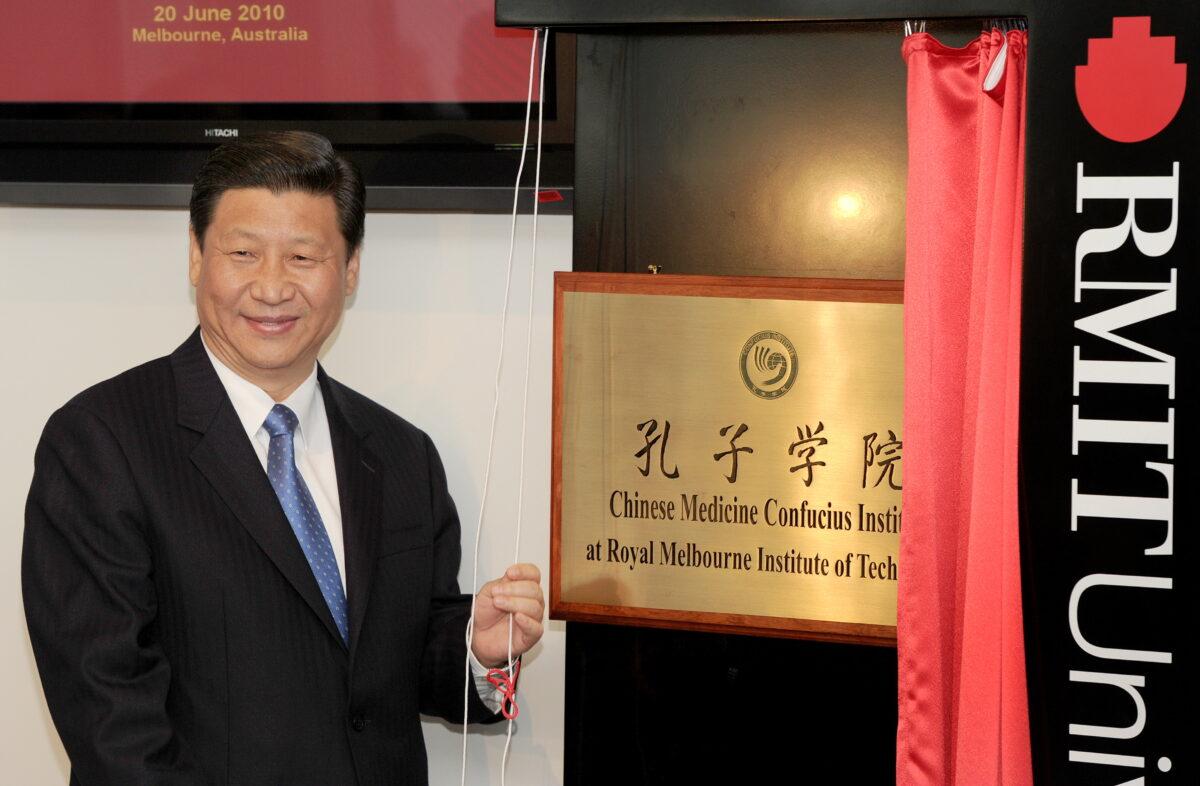 China's Vice President Xi Jinping unveils the plaque at the opening of Australia's first Chinese Medicine Confucius Institute at the RMIT University in Melbourne on June 20, 2010. (William West/AFP via Getty Images)