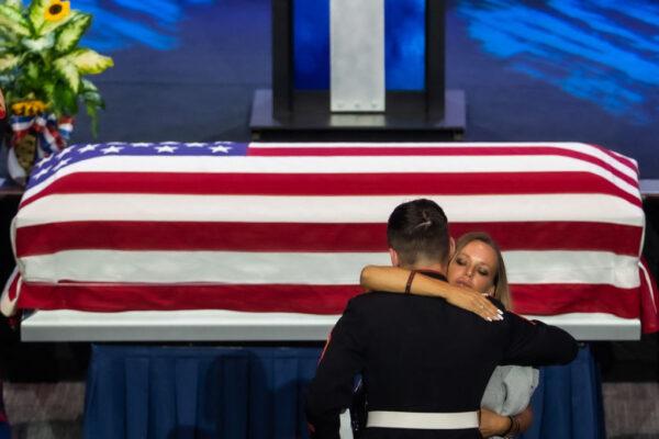 Shana Chappell, mother of slain Marine Kareem Nikoui, hugs a US marine next to the flag-draped casket of her son during a funeral ceremony at the Harvest Christian Fellowship in Riverside, Calif., on Sept. 18, 2021.(Apu Gomes/AFP via Getty Images)