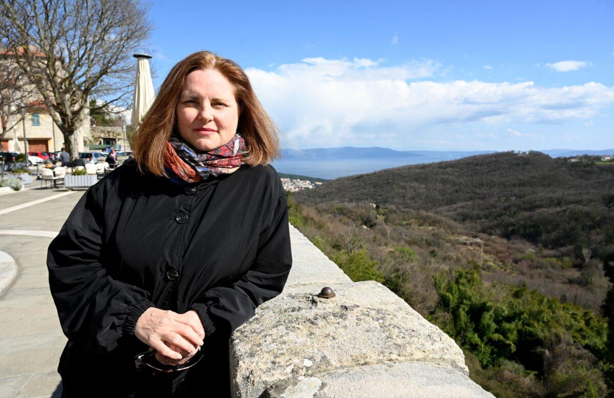 American marketing consultant and digital nomad Melissa Paul poses in the old part of Labin, a hilltop town overlooking the Adriatic known for its cobblestone streets, in Croatia, on March 18, 2021. With a stunning coastline and the Mediterranean lifestyle, Croatia tries to position itself as a perfect spot for remote workers and boost its key tourism industry hard-hit by the pandemic. (Denis Lovrovic/AFP via Getty Images)