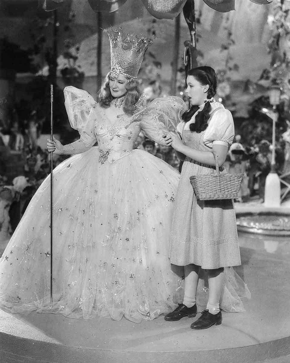 Billie Burke and Judy Garland in "The Wizard of Oz" (1939) promotional photo. (Public Domain)