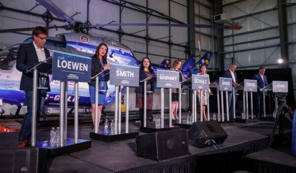 (L–R) UCP leadership candidates Todd Loewen, Danielle Smith, Rajan Sawhney, Rebecca Schulz, Leela Aheer, Travis Toews, and Brian Jean participate in a debate in Medicine Hat, Alta., on July 27, 2022. (Jeff McIntosh/The Canadian Press)