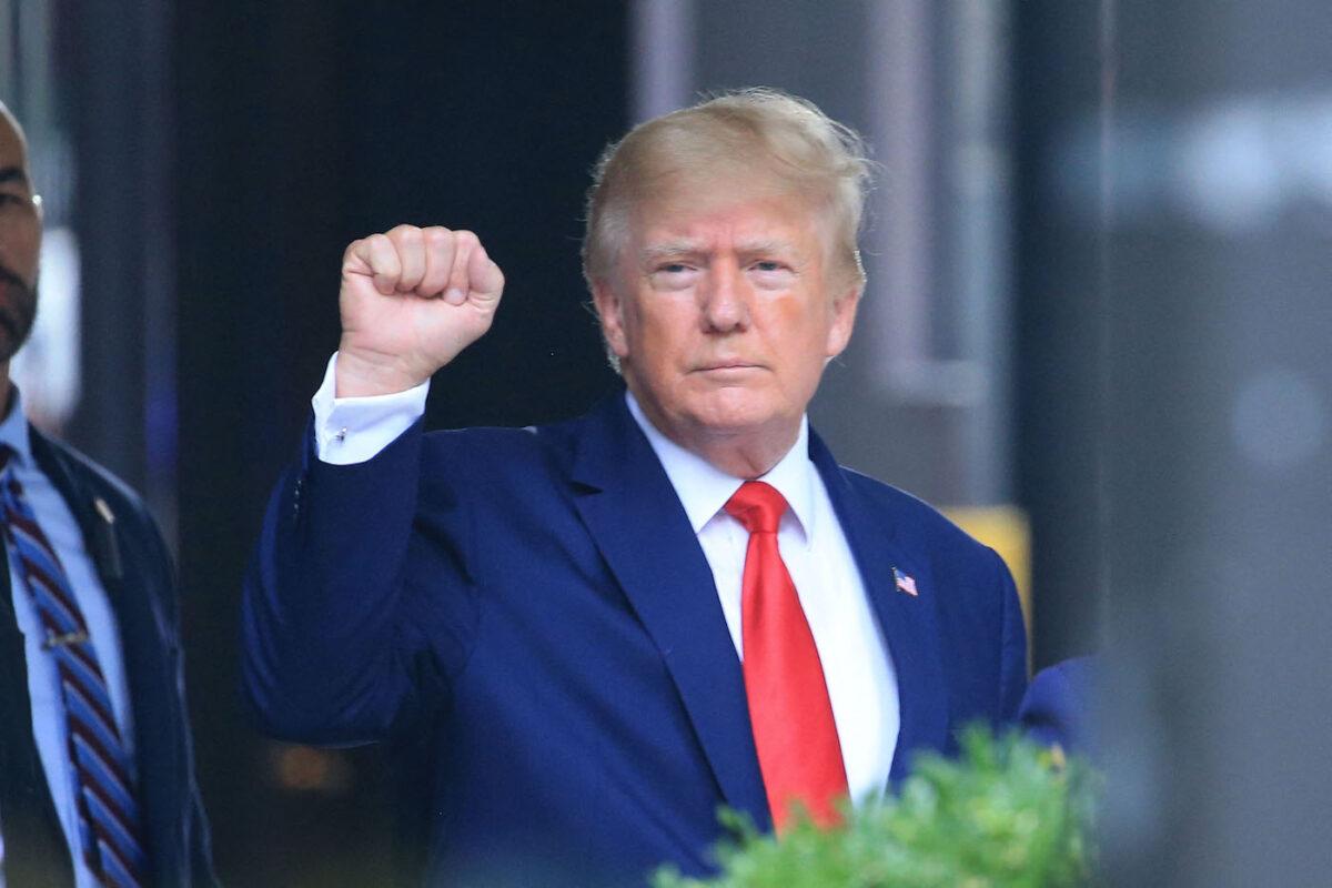 Former U.S. President Donald Trump raises his fist while walking to a vehicle outside of Trump Tower in New York City on Aug. 10, 2022. (Stringer/AFP via Getty Images)