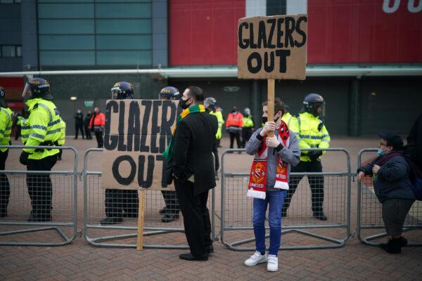 Fans protest outside Old Trafford Stadium ahead of the Premier League match between Manchester United and Liverpool on May 13, 2021, in Manchester, England. Police and ground security staff were prepared for a possible demonstration by United supporters against ownership of Manchester United by the Glazer family. (Christopher Furlong/Getty Images)