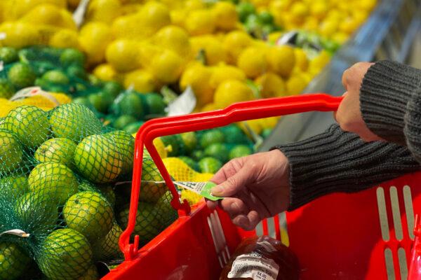 A customer looks at the price of limes at a fruit stand in the central business district in Sydney, Australia, on Aug. 16, 2022. (Lisa Maree Williams/Getty Images)
