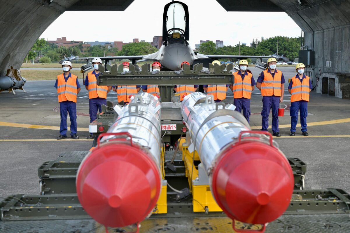 Air Force soldiers stand in front of an armed F-16V fighter jet behind two U.S.-made Harpoon AGM-84 anti-ship missiles during a drill at Hualien Air Force base in Hualien County, Taiwan, on Aug. 17, 2022. (Sam Yeh/AFP via Getty Images)