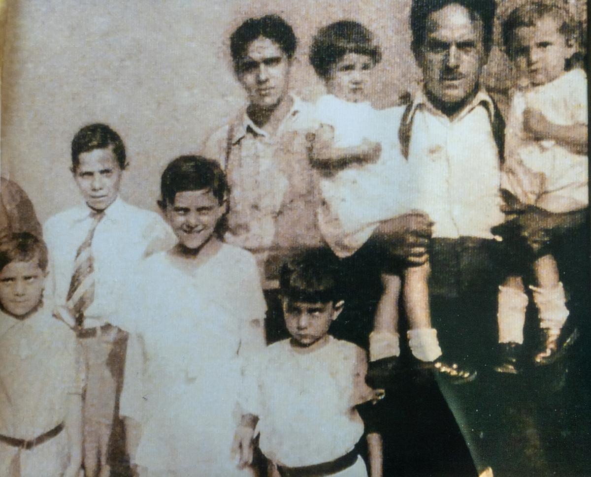 Joe Moraglia (R) in the arm of his father and with his family. (Courtesy of the Moraglias)