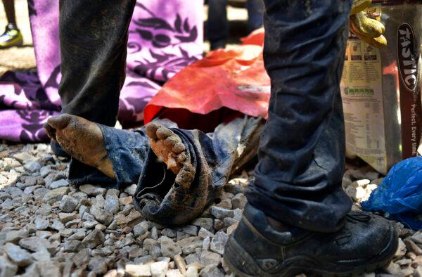The body of an illegal miner lies on the ground after being pulled out at an illegal gold mine in Benoni, outside Johannesburg, on Feb. 18, 2014. (Mujahid Safodien/AFP via Getty Images)