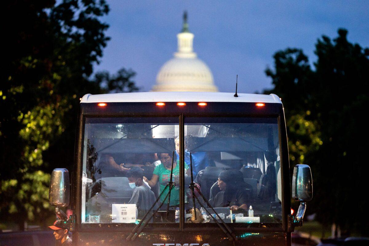 Illegal immigrants, who boarded a bus in Texas, are dropped off within view of the U.S. Capitol building in Washington on Aug. 11, 2022. (Stefani Reynolds/AFP via Getty Images)