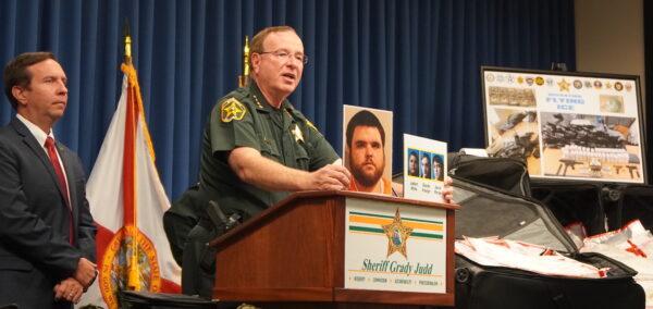 Polk County Sheriff Grady Judd shows the media pictures of suspects after busting an international drug ring on Aug. 19, 2022 (Jann Falkenstern, The Epoch Times)