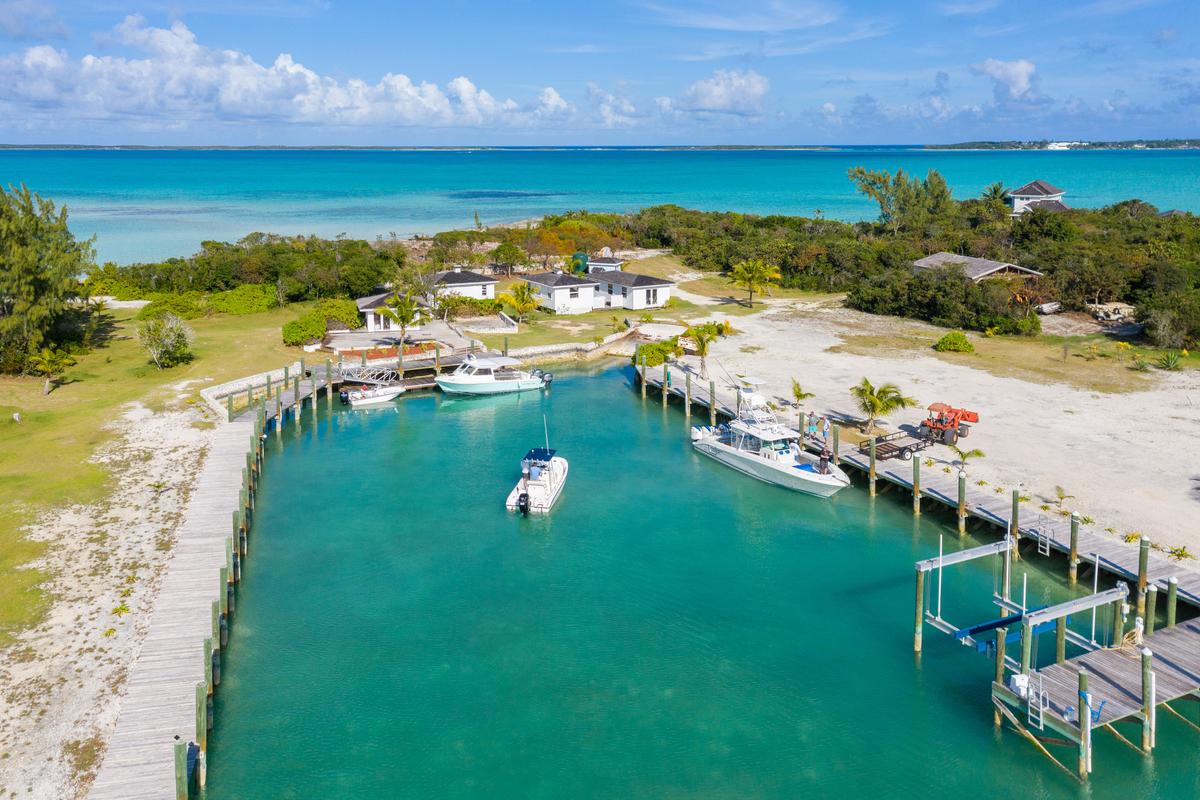 The island’s sheltered harbor has ample draft and space for as many as five large center console boats. Improvements include multiple docks, ramps, lifts, maintenance facilities, and a private launch. (Courtesy of Damianos Sotheby’s International Realty)
