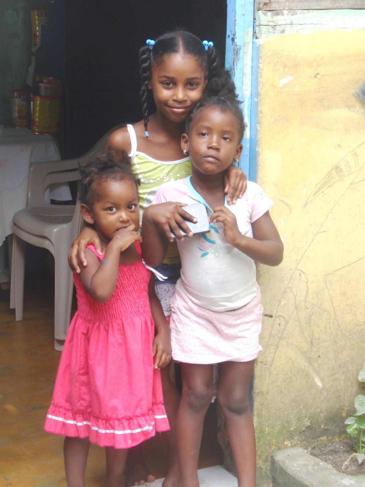 People such as these girls in a Dominican Republic village are unfailingly welcoming to visitors. (Courtesy of Victor Block)