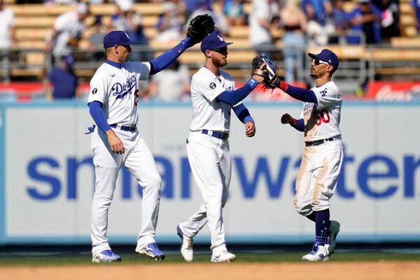 From left to right, Los Angeles Dodgers' Trayce Thompson, Cody Bellinger and Mookie Betts celebrate a win over the Miami Marlins in a baseball game in Los Angeles, Aug. 21, 2022. (Marcio Jose Sanchez/AP Photo)