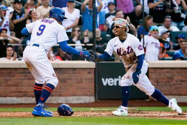 New York Mets' Brandon Nimmo and Francisco Lindor celebrate after scoring during the third inning of a baseball game against the Atlanta Braves in New York on Aug. 7, 2022. (Julia Nikhinson/AP Photo)