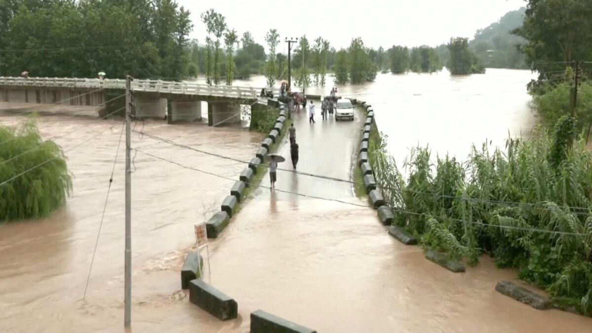 A flooded bridge following heavy rains in Mandi, Himachal Pradesh, India, on Aug. 20, 2022, in a screenshot from video. (ANI via Reuters)