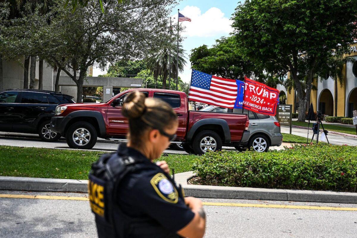 Supporters of former U.S. President Donald Trump drive around the Paul G. Rogers Federal Building & Courthouse in West Palm Beach, Fla. as the court holds a hearing on Aug. 18, 2022, to determine if the affidavit used by the FBI as justification for the raid of Trump's Mar-a-Lago estate should be unsealed. (Chandan Khanna/AFP via Getty Images)