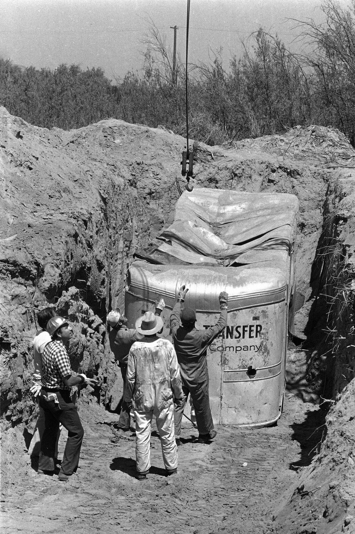 Officials remove a moving van buried at a rock quarry in Livermore, Calif., on July 20, 1976. Twenty-six Chowchilla school children and their bus driver Ed Ray were held captive in the van. (James Palmer/AP Photo)