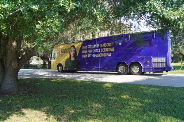 The campaign bus of Florida's commissioner of agriculture and consumer service, Nikki Fried, navigates a tight turn into a parking lot in Summerfield for a planned campaign stop on Aug. 19. (Natasha Holt/The Epoch Times)
