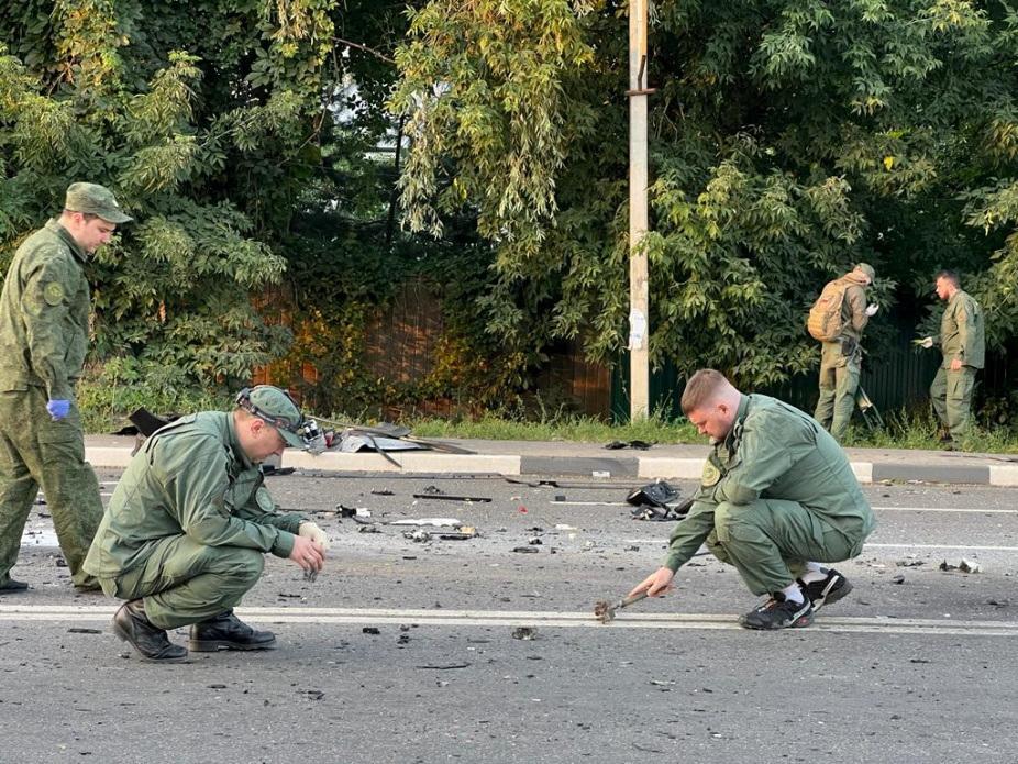 Investigators work at the site of a suspected car bomb attack that killed Darya Dugina, daughter of Russian politologist Alexander Dugin, in the Moscow region, Russia, on Aug. 21, 2022. (Investigative Committee of Russia via Reuters)