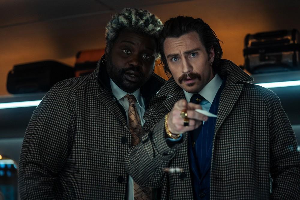 Lemon (Brian Tyree Henry, L) and Tangerine (Aaron Taylor-Johnson) are two cockney-accented killers in "Bullet Train." (Columbia Pictures/Sony Pictures Releasing).