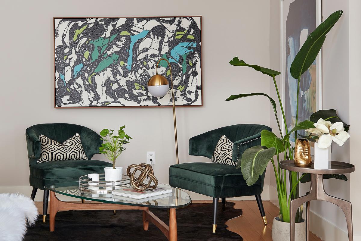 Green accent chairs and artwork with pops of green adds a sense of richness in this seating area. (Scott Gabriel Morris/TNS)