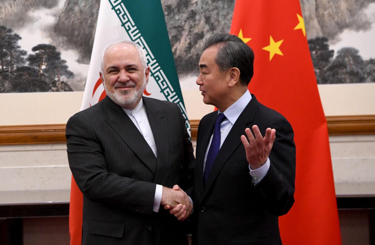 Iran's Foreign Minister Mohammad Javad Zarif (L) shakes hands with China's Foreign Minister Wang Yi (R) during a meeting at the Diaoyutai state guest house on Dec. 31, 2019 in Beijing, China. (Noel Celis - Pool/Getty Images)