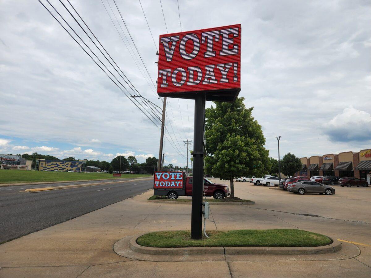 Signs at a shopping center in Muskogee, Oklahoma encourage residents to vote in the state's GOP primary runoff elections on Aug. 23. (Jeff Louderback/The Epoch Times)