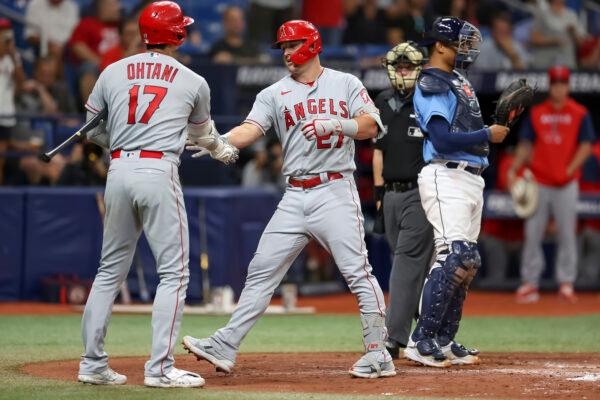 Los Angeles Angels' Shohei Ohtani (17) congratulates Mike Trout on his home run in front of Tampa Bay Rays catcher Christian Bethancourt during the sixth inning of a baseball game in St. Petersburg, Fla., Aug. 23, 2022. (Mike Carlson/AP Photo)