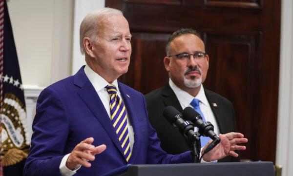 President Joe Biden (left), joined by Education Secretary Miguel Cardona, speaks on student loan debt in the Roosevelt Room of the White House on Aug. 24, 2022. (Alex Wong/Getty Images)