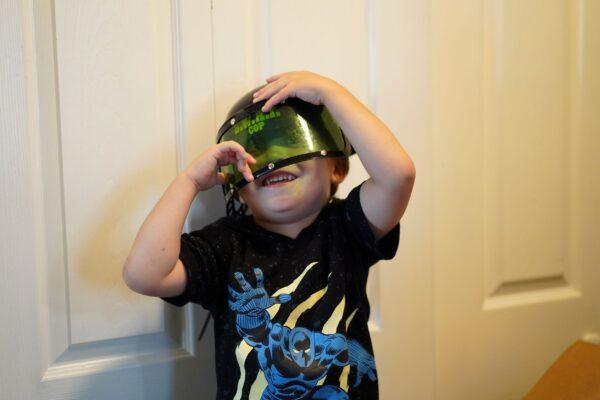 Weston Austin was happy to find a toy SWAT helmet among donations at great-grandmother Vivian Van Orden's house in Port Jervis on Aug. 22, 2022. (Cara Ding/The Epoch Times)