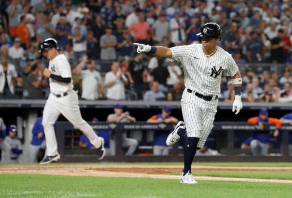 Oswaldo Cabrera #95 of the New York Yankees gestures towards his dugout after drawing a bases loaded walk during the fourth inning against the New York Mets scoring teammate Anthony Rizzo #48 at Yankee Stadium in New York City, August 23, 2022. (Jim McIsaac/Getty Images)