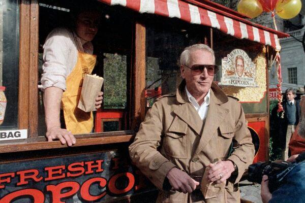 Paul Newman donates a popcorn stand to the City of New York on Nov. 15, 1984, for his "Newman's Own Popcorn," with profits donated to charity. (Richard Drew/AP Photo)