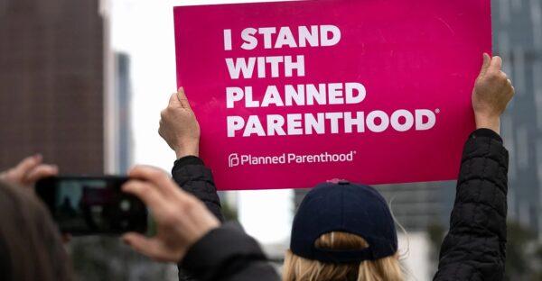 An activist holds a sign supporting Planned Parenthood, in Los Angeles, on May 21, 2019. (Ronen Tivony/Getty Images)