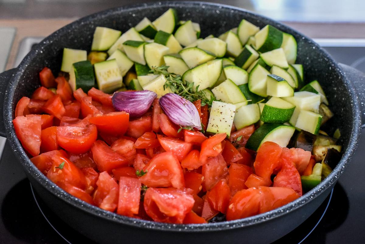 Add the tomatoes, zucchini, garlic, and herbs. Stir gently. (Audrey Le Goff)