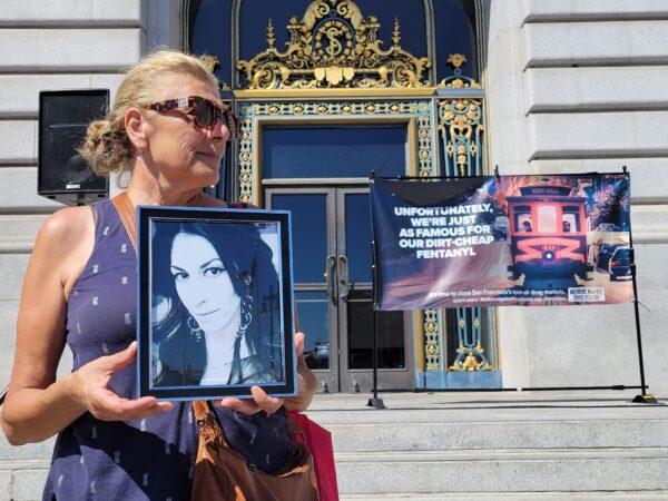 A mother attends a rally in front of City Hall in San Francisco on Aug. 21, 2022, for National Fentanyl Prevention and Awareness Day. (Jason Blair/Epoch Times)