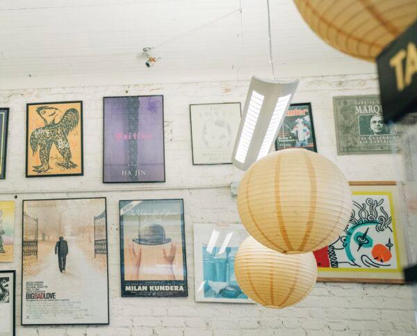 The walls of the bookstore are adorned with vintage prints and posters. (White Studio Creative)